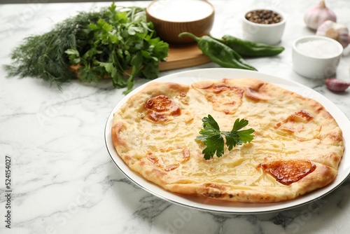 Delicious khachapuri with cheese on white marble table