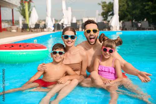Happy family in swimming pool on sunny day © New Africa