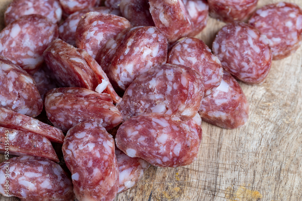 sliced thin sausage with bacon on a wooden dish sliced thin sausage with bacon on a wooden dish
