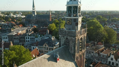 Famous Sint Janskerk Clock Tower With Gouda City Views During Sunny Day In The Netherlands. Aerial Orbiting photo