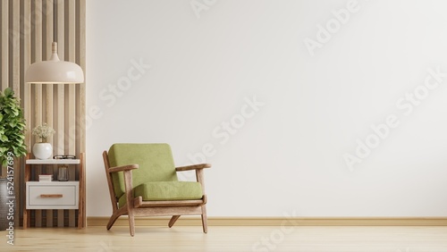 Living room has a green armchair on empty white color wall background. photo