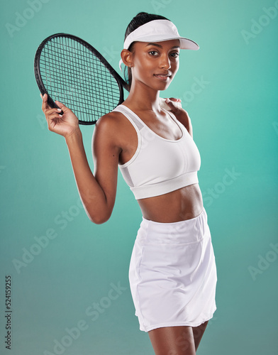 Tennis player, sports uniform and racket in the hands of a beautiful woman looking happy and ready to play with a positive attitude. Confident, fit and athletic female against a studio background