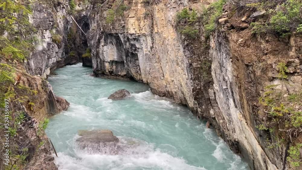 Teal water of the Kootenay River flows through Marble Canyon in Kootenay National Park, British Columbia Canada in the Canadian Rockies Teal water of the Kootenay River flows through Marble Canyon in Kootenay National Park, British Columbia Canada in the Canadian Rockies