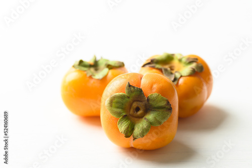 Ripe persimmon fruit on white background