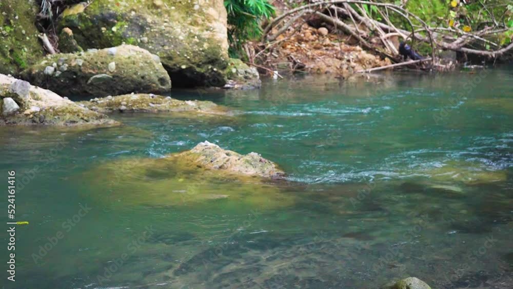 Blue colored water lowing down following the stream with a change of color due to weather Blue colored water lowing down following the stream with a change of color due to weather