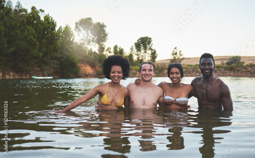 Friends couples and lake swimming together in summer or spring in bikinis on a fun vacation. Happy, relaxed and diverse young people enjoy the freedom, river and dam outdoors on a nature vacation © Kirsten D/peopleimages.com