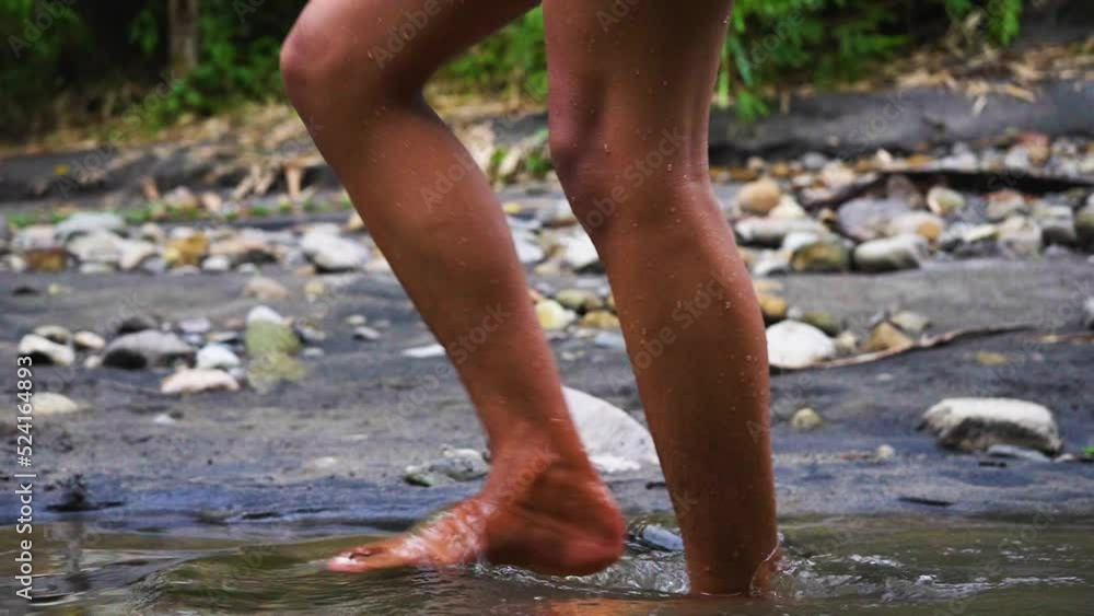 A man keep walking confidently at the side of a river A man keep walking confidently at the side of a river