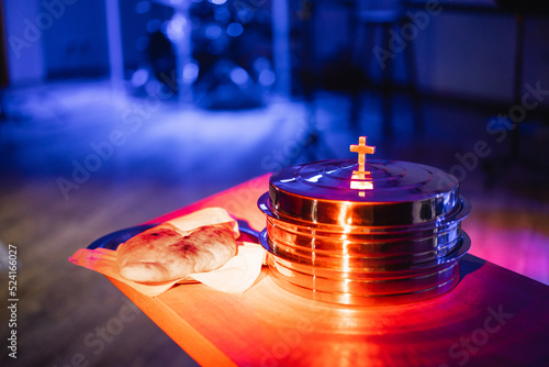 The process of breaking bread in the modern church. Breaking bread ceremony in protestant church. Religious tradition of breaking bread. Bread and wine.