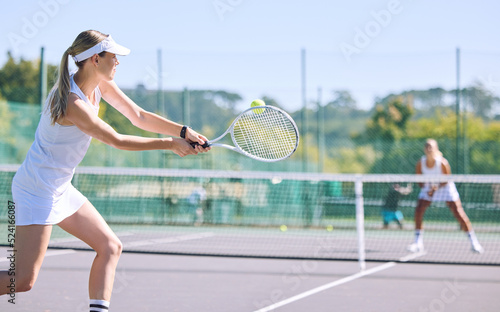 Sports and active tennis player hitting ball with racket equipment during a competitive match or hobby activity on a court. Athletic, sporty and fit woman playing in a tournament game with sportswear