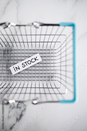 In stock text inside of shopping basket, shopping and retail