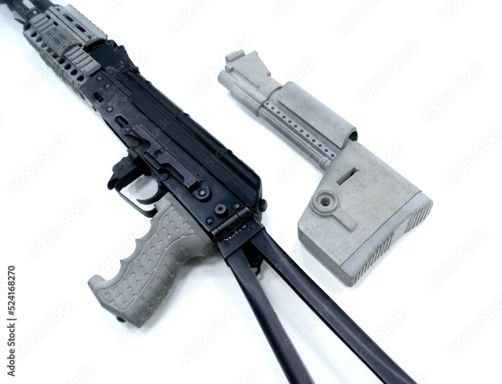 Detail of a weapon printed on a 3D printer. A weapon detail printed on a 3D printer from powder isolated on white background. Detail of a weapon printed on a 3D printer. A weapon detail printed on a 3D printer from powder isolated on white background.