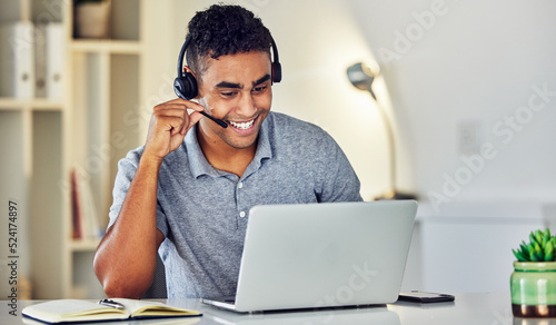 Call center telemarketing agent with headset and laptop working, assisting or talking to online web user. Male sales representative advisor with excellent customer service skills and business advice photo