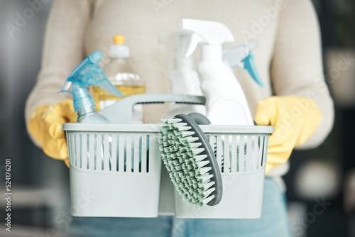 Closeup of house cleaning supplies, floor scrubbing and washing tools or products in an organized basket. Cleaner, housekeeper or maid with spray bottles and hygiene equipment for work or chores photo