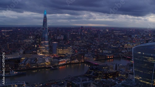 Wallpaper Mural Panoramic Drone establishing shot of illuminated Central London at dusk. Iconic landmarks like the London Bridge, The Shard and the River Thames standing out from the rest of the city. Torontodigital.ca