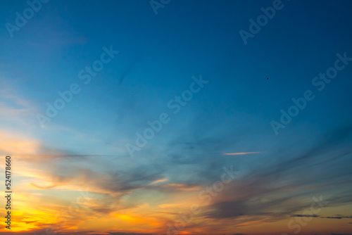 The sky at sunset or sunrise with orange clouds and a blue tint © Olga