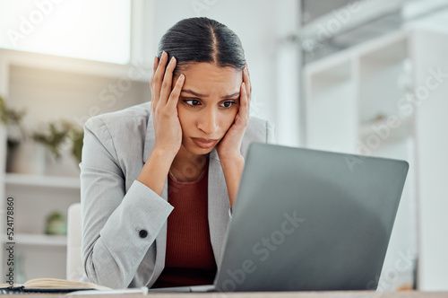 Pain, headache and stressed finance manager feeling sick, tired and worried about a financial problem at her startup company. Young and frustrated professional businesswoman working at an office photo