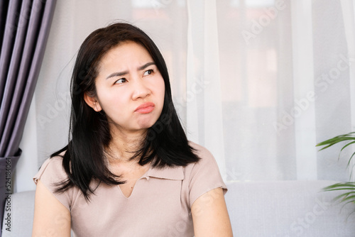 angry Asian woman with unhappy face having mood swings caused by PMS or Premenstrual Syndrome