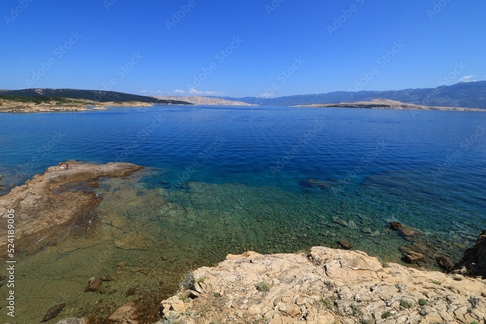 The rocky shores of the beaches in Croatia are azure blue in the Adriatic Sea

