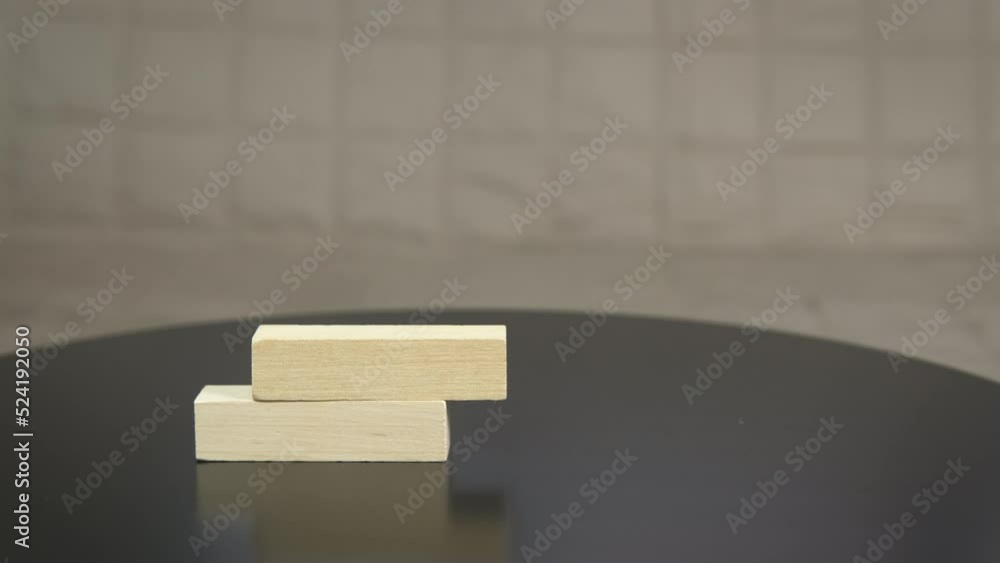 Table game with bars. A child construct something from wooden blocks on the table. Table game with bars. A child construct something from wooden blocks on the table.