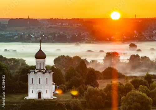 Sun is rising over the Church of the Intercession on the Nerl river (Vladimir region, Russia)