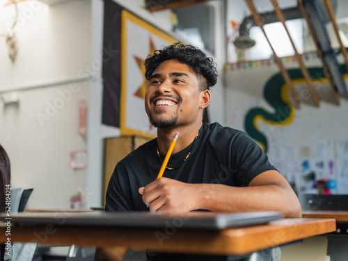 Native boy with curly hair smiles big during class