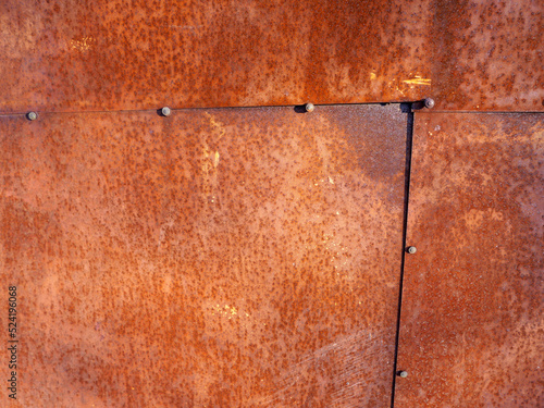 beautiful background of an old solid metal garage wall with corrosion and rust