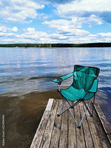 beautiful river view with a fishing chair on the pier that can be used as a mockup