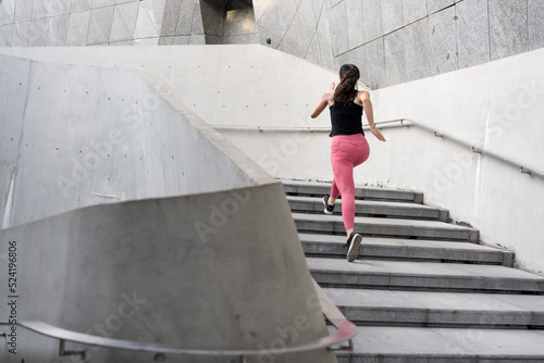 Young woman running fast on the ladder