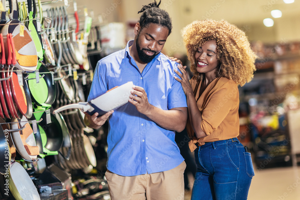 Fototapeta premium African American couple purchasing dishes in supermarket