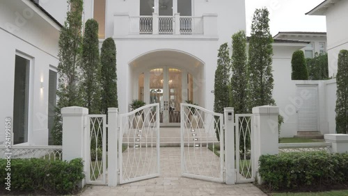 Luxury white color villa with modern looks, walking in POV dolly forward photo