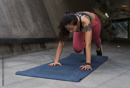 Asian woman exercising on yoga mat