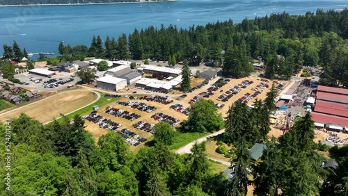 Wide aerial view of a filled parking lot at the Langley, WA county fair near the ocean. photo