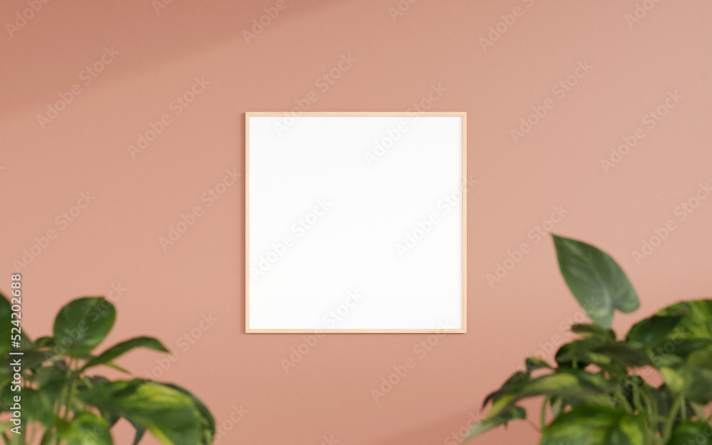 Fototapeta premium Clean and minimalist front view square wooden photo or poster frame mockup hanging on the wall with blurry plant. 3d rendering.