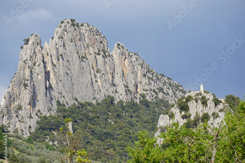 rocky mountain landscape with white statue on cliff in buis les barronnies france