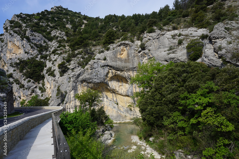 rocky cliffs by the roadway and the river in buis les barronnies france