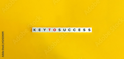 Key to Success Idiom and Banner. Letter Tiles on Yellow Background. Minimal Aesthetics. photo