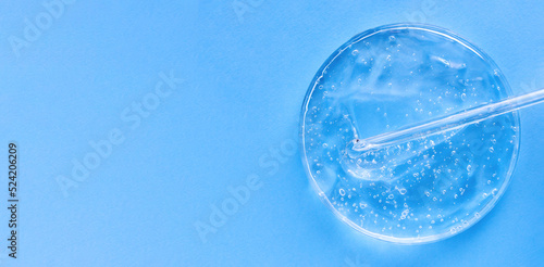 banner serum gel closeup in petri dish on a blue background with place for text