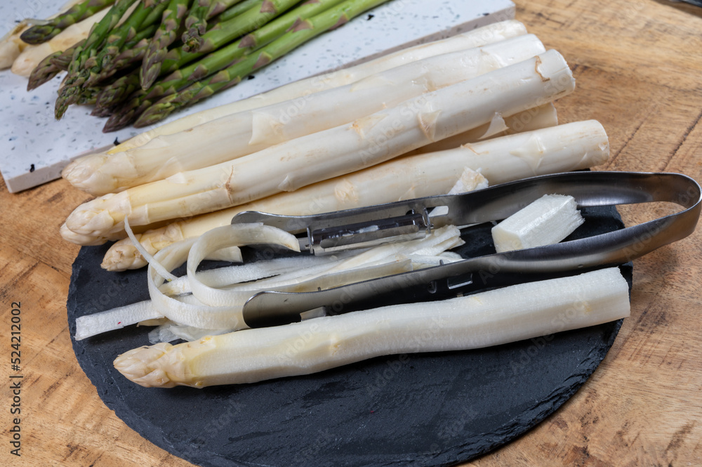 Cooking of fresh white asparagus vegetables, peeler knife for asparagus