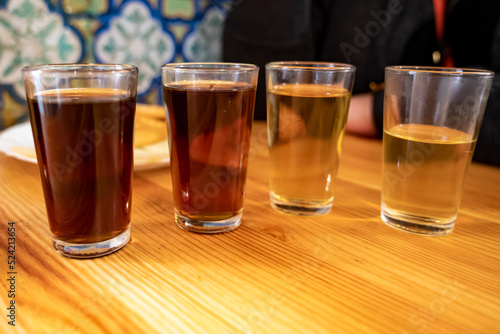 Tasting of different sweet wines from wooden barrels on old bodega in central part of Malaga, Andalusia, Spain