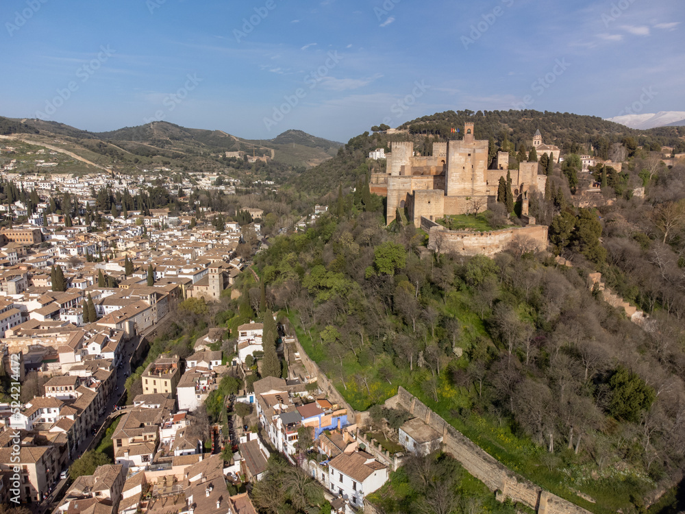 Aerial panoramic view on buildings, old district, mountains and Alhambra palace, world heritage city Granada, Andalusia, Spain