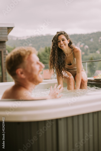 Young couple enjoying in ou...