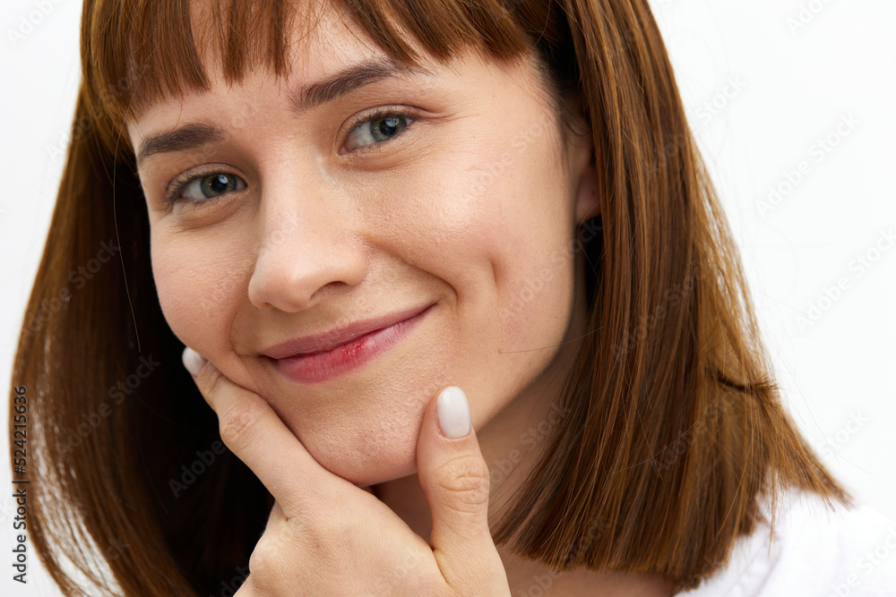 a close horizontal photo of a funny, thoughtful woman in a white T-shirt on a white background holding a finger near her face in reflection a close horizontal photo of a funny, thoughtful woman in a white T-shirt on a white background holding a finger near her face in reflection