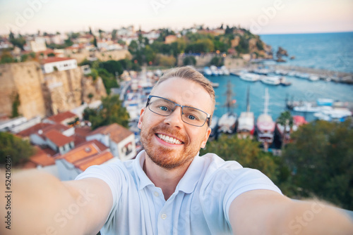 Travel selfie photo Man tourist take background Kaleici Antalya old town port, Mediterranean Sea, Turkey