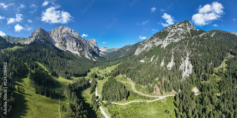 tyrolean alps with soil with the managed hut musauer alm in the middle of green forest and meadows