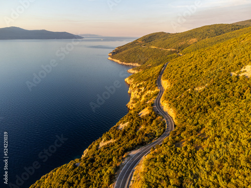 Winding coastal road at sunrise