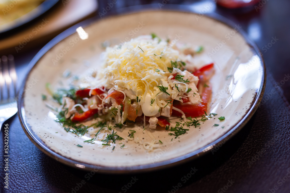 Fresh salad with chicken, vegetables and grated cheese on plate Fresh salad with chicken, vegetables and grated cheese on plate