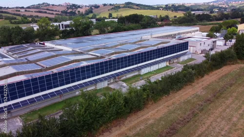 Solar panels installed on the walls and roof of an industrial warehouse. Green energy concept Solar panels installed on the walls and roof of an industrial warehouse. Green energy concept