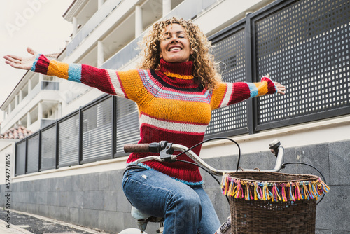 Canvas Print Happiness and joyful emotion expression for young woman riding a bike in the city