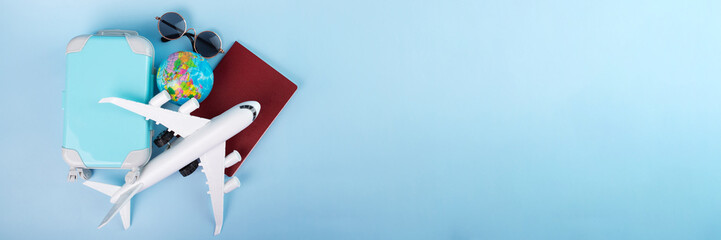 travel visa, flight insurance, international flights, tourism and vacation, passport, plane and luggage on a blue background with copy space,banner