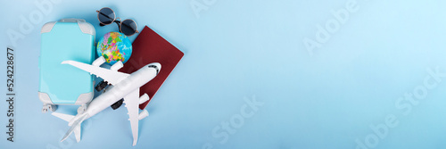 travel visa, flight insurance, international flights, tourism and vacation, passport, plane and luggage on a blue background with copy space,banner